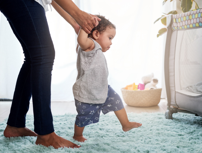 Parent helping the baby walk
