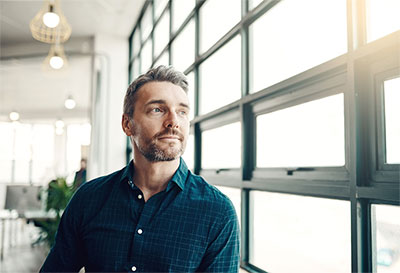 man gazing out the window