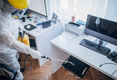 Someone sanitizing an office
