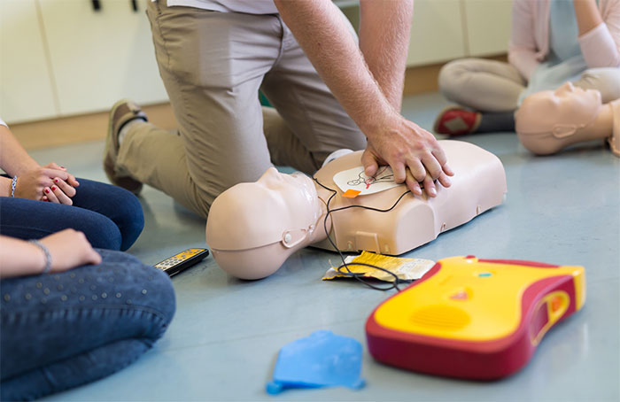 CPR instructor showing proper technique