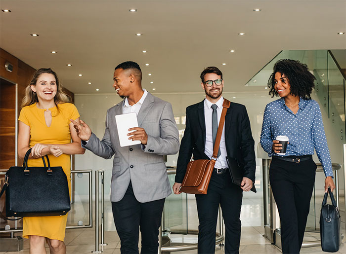 Four businesspeople leaving a meeting.