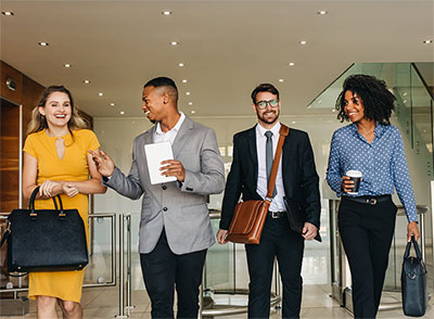 Four businesspeople leaving a meeting.