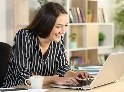 Woman typing on computer.
