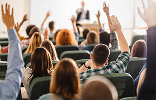 Presenter selecting audience menber whose hand is raised